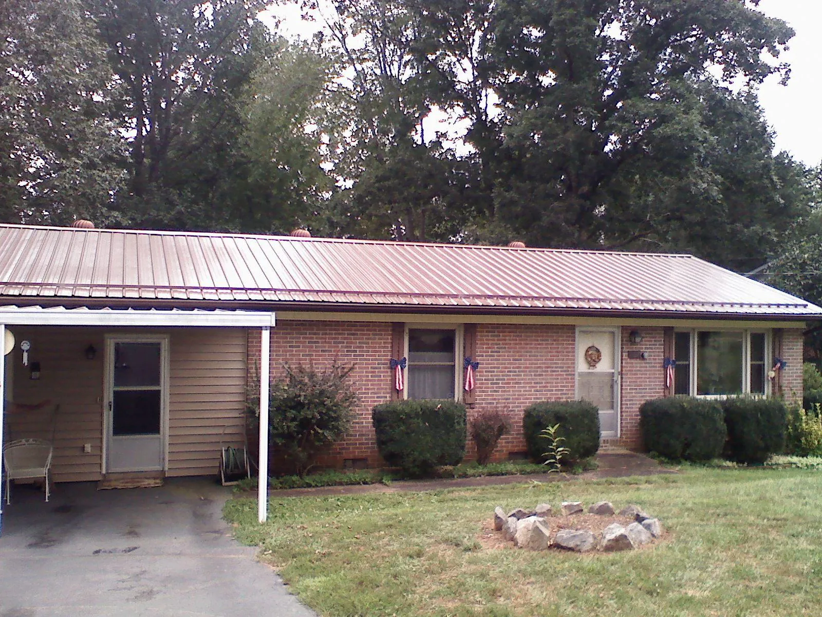Bronze metal roof and carport on a brick ranch home — Roof Repair work by our crew in Mine Hill