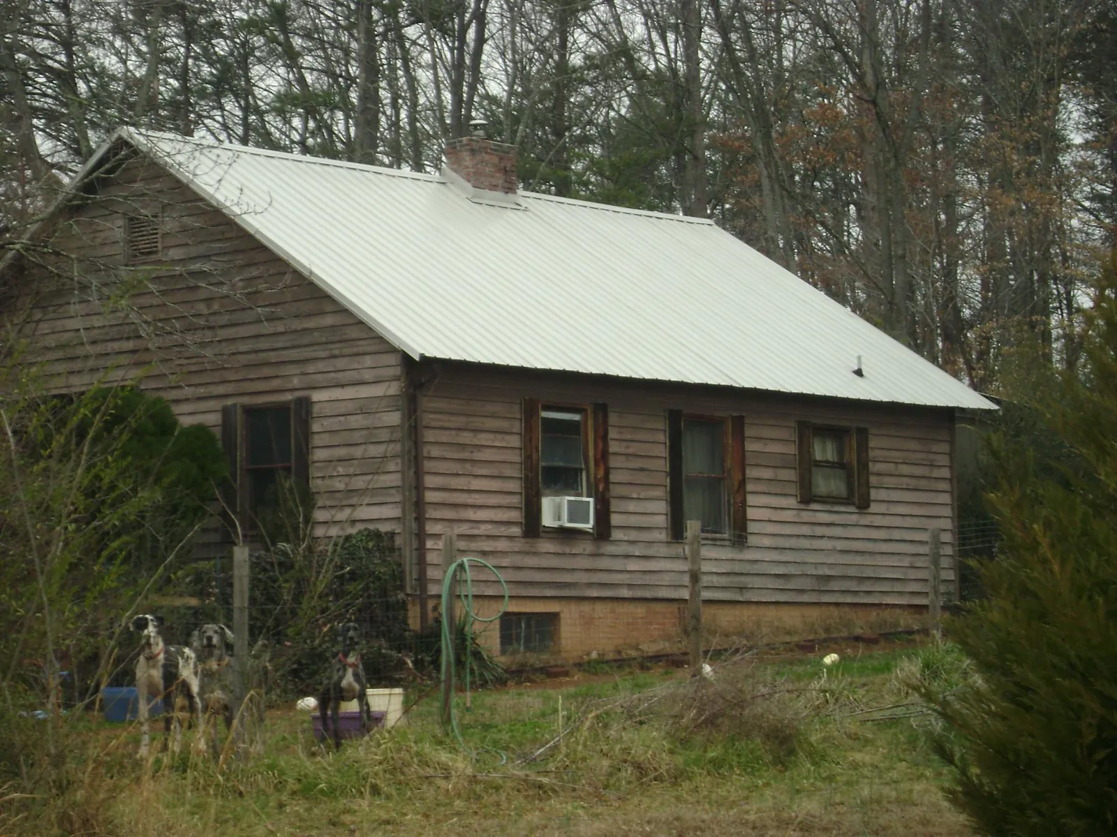 White metal roof on an old wood sided farmhouse, from a Metal Roof Installation job in Mine Hill